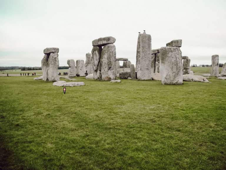 Green grass with big tall rocks stacked in a circular motion