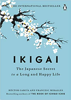 the Japanese secret to a long and happy life book cover in blue with  painted white orchids on a black stem