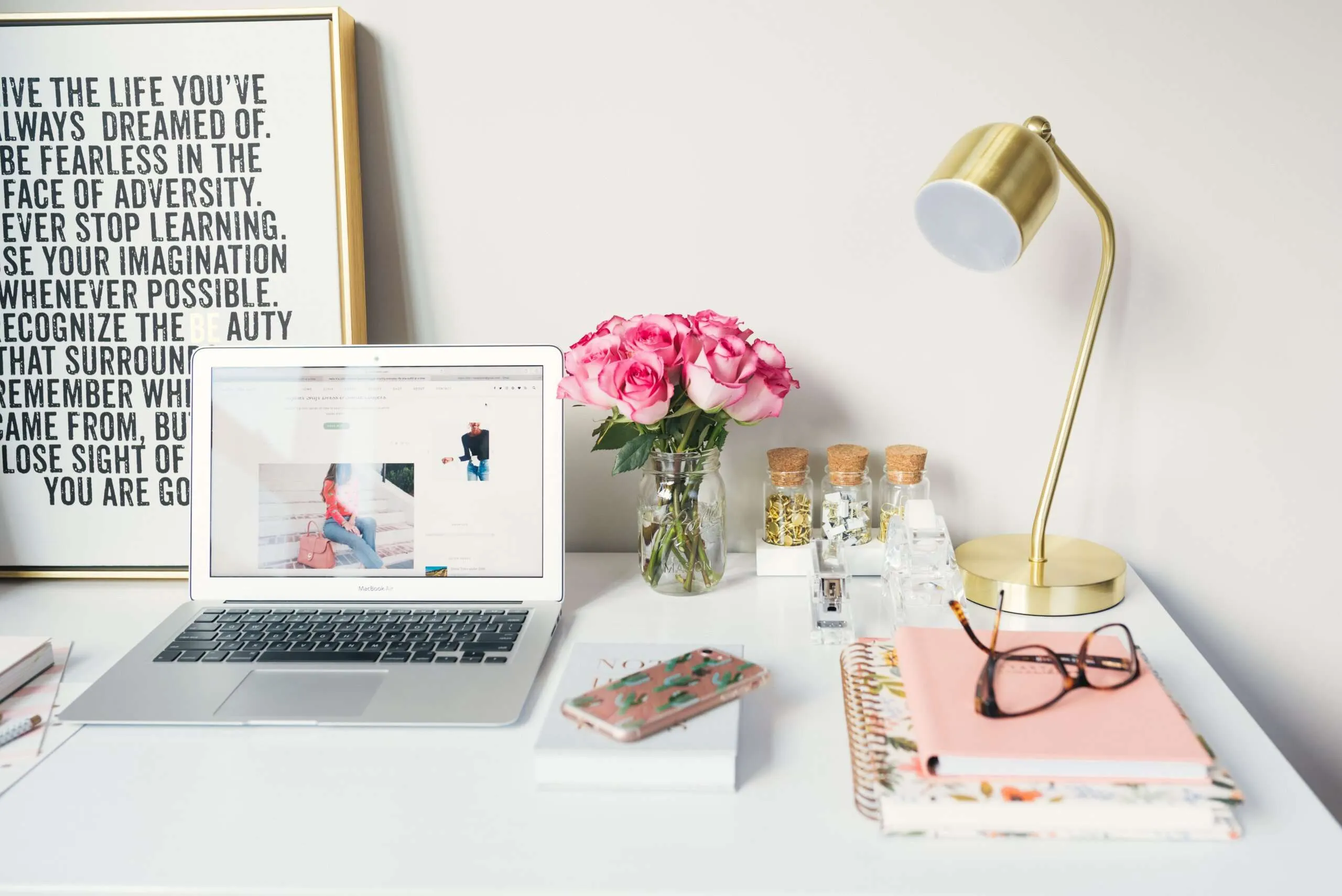 working at home quotes -table with laptop, flowers, lamp and quotes