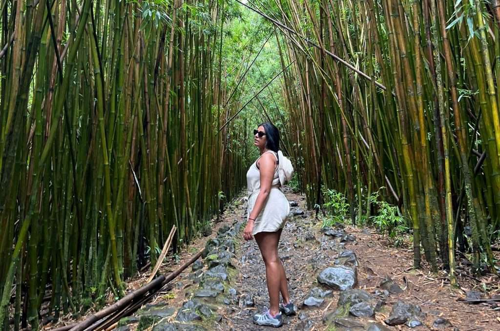 an image of a brown woman standing in the middle of a bamboo forest to encourage you to spend more time with nature